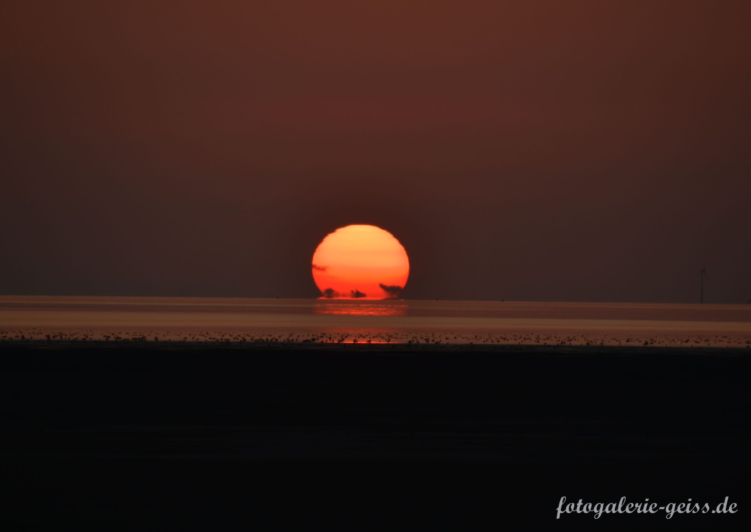 Sonnenuntergang im Watt an der Nordsee bei Pilsum